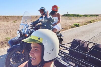 Lisbon - Private Vintage Sidecar Tour to Sesimbra's Coast - Stop 2: Beach time with sand, rocks, and umbrellas nearby